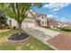 Lovely brick home with a well-kept lawn, brick driveway, and an attached two-car garage and front yard landscaping at 2311 Norbury Se Cv, Smyrna, GA 30080