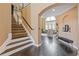 Open foyer showcasing hardwood floors, a staircase, and an archway leading to the living room at 2311 Norbury Se Cv, Smyrna, GA 30080