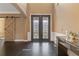 Elegant foyer featuring decorative glass doors, a sliding barn door, rich hardwood floors, and stylish accents at 2311 Norbury Se Cv, Smyrna, GA 30080