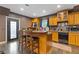 A well-lit kitchen featuring a breakfast bar, wooden cabinets, modern appliances, and a view to the outdoors at 2311 Norbury Se Cv, Smyrna, GA 30080