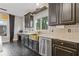 Kitchen featuring a stainless steel dishwasher, marbled countertop and tiled backsplash at 2311 Norbury Se Cv, Smyrna, GA 30080