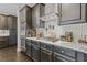 Close up of kitchen features stainless steel appliances, marbled countertops, and tiled backsplash at 2311 Norbury Se Cv, Smyrna, GA 30080