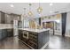 This large kitchen includes an island with marble countertops and modern lighting at 2311 Norbury Se Cv, Smyrna, GA 30080