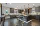 Spacious kitchen features an island with bar stool seating and dark wood cabinets at 2311 Norbury Se Cv, Smyrna, GA 30080