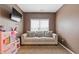 Comfortable living room space featuring a plush sofa, a TV, and a toy kitchen perfect for relaxation and play at 2311 Norbury Se Cv, Smyrna, GA 30080