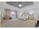 Spacious main bedroom features a tray ceiling, light walls, and cozy carpet creating a luxurious retreat at 2311 Norbury Se Cv, Smyrna, GA 30080