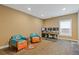 A well-lit home office featuring a large desk, rolling chair, and a Miami Dolphins-themed seating area at 2311 Norbury Se Cv, Smyrna, GA 30080