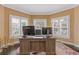 Bright home office featuring large windows, a stylish desk, and ample workspace at 2311 Norbury Se Cv, Smyrna, GA 30080