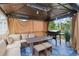 A covered outdoor living area with comfortable seating, a table, and a grill for outdoor dining and entertaining at 2311 Norbury Se Cv, Smyrna, GA 30080