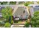Aerial view of home's backyard with a deck and patio, complemented by lush greenery, providing a private outdoor space at 2311 Norbury Se Cv, Smyrna, GA 30080