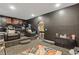 A black theater room with leather recliners, tiered seating, carpeted floor, and an archway to the billiards room at 2311 Norbury Se Cv, Smyrna, GA 30080