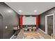 A theater room featuring a large white screen with red curtains, carpeted floor, and wall decor at 2311 Norbury Se Cv, Smyrna, GA 30080