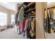 Spacious walk-in closet with custom shelving and a full-length mirror for style and functionality at 2311 Norbury Se Cv, Smyrna, GA 30080