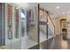 Gorgeous wine cellar under the staircase featuring glass enclosure and custom wine racks for ample bottle storage at 2311 Norbury Se Cv, Smyrna, GA 30080