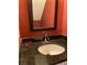 Close-up of a bathroom sink with granite countertop and framed mirror at 3082 Revere Ct, Atlanta, GA 30340