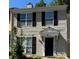 Two story home with cream colored siding and black shutters at 3082 Revere Ct, Atlanta, GA 30340