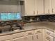 Kitchen featuring a tile backsplash and stainless steel sink at 3082 Revere Ct, Atlanta, GA 30340
