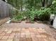 Tile patio and garden with lots of greenery. The garden is surrounded by a brick border at 3082 Revere Ct, Atlanta, GA 30340