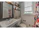 Bright bathroom features a floral shower curtain, large mirror, and floating shelves above the toilet at 733 Frederica Ne St # 2, Atlanta, GA 30306