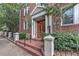 Inviting brick building entrance featuring a covered porch with brick stairs and elegant white pillars and railings at 733 Frederica Ne St # 2, Atlanta, GA 30306