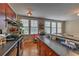 Bright kitchen showcasing dark cabinets, hardwood floors, plenty of natural light and breakfast bar overlooking the adjacent living area at 733 Frederica Ne St # 2, Atlanta, GA 30306