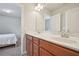 Bright bathroom featuring double sinks, cherry cabinets, modern fixtures, and a tile floor at 2100 Baywood Sw Blvd, Austell, GA 30106