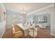 Open dining room with large table and seating, seamlessly flows into the living area at 2100 Baywood Sw Blvd, Austell, GA 30106