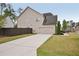 View of a two-story home's side and back exterior with garage and driveway at 2100 Baywood Sw Blvd, Austell, GA 30106