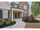 Inviting front porch with elegant columns, detailed brickwork, and mature landscaping at 2100 Baywood Sw Blvd, Austell, GA 30106
