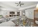 Open-concept living room with a large gray sectional couch, modern rug, and view of the kitchen at 2100 Baywood Sw Blvd, Austell, GA 30106