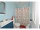 Cozy bathroom features a vanity sink, toilet, and shower with colorful curtain at 2176 Cold Springs Cir, Lithonia, GA 30058