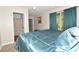 Bed in the bedroom across from a doorway to the bathroom, window with teal curtains at 2176 Cold Springs Cir, Lithonia, GA 30058
