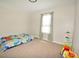 Cozy bedroom with soft carpet, a cute window, and bright natural lighting at 2176 Cold Springs Cir, Lithonia, GA 30058