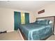 Bedroom with a teal comforter, framed art on the wall, and curtains on the window at 2176 Cold Springs Cir, Lithonia, GA 30058