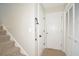 Home entryway featuring a carpeted stairway, coat closet, and front door with a storm door at 2176 Cold Springs Cir, Lithonia, GA 30058