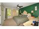 The main bedroom has a large bed, ceiling fan, two windows, and matching ornate dresser with decorative lamps at 2176 Cold Springs Cir, Lithonia, GA 30058