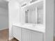 Bright bathroom featuring a double vanity, large mirror, and tub with shower at 325 Freeman Cir, Villa Rica, GA 30180
