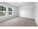 Cozy bedroom featuring ample natural light from two windows and neutral carpeting at 325 Freeman Cir, Villa Rica, GA 30180