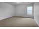 Carpeted bedroom with white walls and a window providing ample natural light at 325 Freeman Cir, Villa Rica, GA 30180