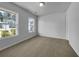 Bright bedroom with carpet, two windows with a neighborhood view and a ceiling light at 325 Freeman Cir, Villa Rica, GA 30180