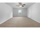 Large bedroom with carpet, ceiling fan, and natural light from the large window at 325 Freeman Cir, Villa Rica, GA 30180
