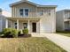 Charming two-story home with a covered front porch, one-car garage, and well-maintained landscaping at 325 Freeman Cir, Villa Rica, GA 30180