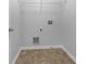 Dedicated laundry room with flooring, utility connections, and built-in shelving for storage at 325 Freeman Cir, Villa Rica, GA 30180