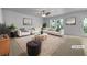 Bright living room with neutral walls, ceiling fan, modern furniture, and large windows at 325 Freeman Cir, Villa Rica, GA 30180