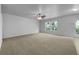 Spacious living room with plush carpeting, large windows, ceiling fan, and patio door at 325 Freeman Cir, Villa Rica, GA 30180