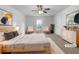 Bright main bedroom featuring a queen bed, ceiling fan, and a view of the neighborhood at 325 Freeman Cir, Villa Rica, GA 30180