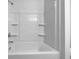 Clean and well-maintained white tub with shower and built-in shelves at 325 Freeman Cir, Villa Rica, GA 30180