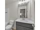 A modern bathroom with vanity, mirror, light fixture, toilet, and tiled shower with tub at 4142 Spring Valley Cir # 65, Tucker, GA 30084