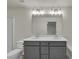 Bathroom featuring double vanity, undermount sinks, a large mirror and modern lighting at 4142 Spring Valley Cir # 65, Tucker, GA 30084