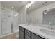 Bright bathroom featuring double sinks, walk-in shower, and modern fixtures at 4142 Spring Valley Cir # 65, Tucker, GA 30084
